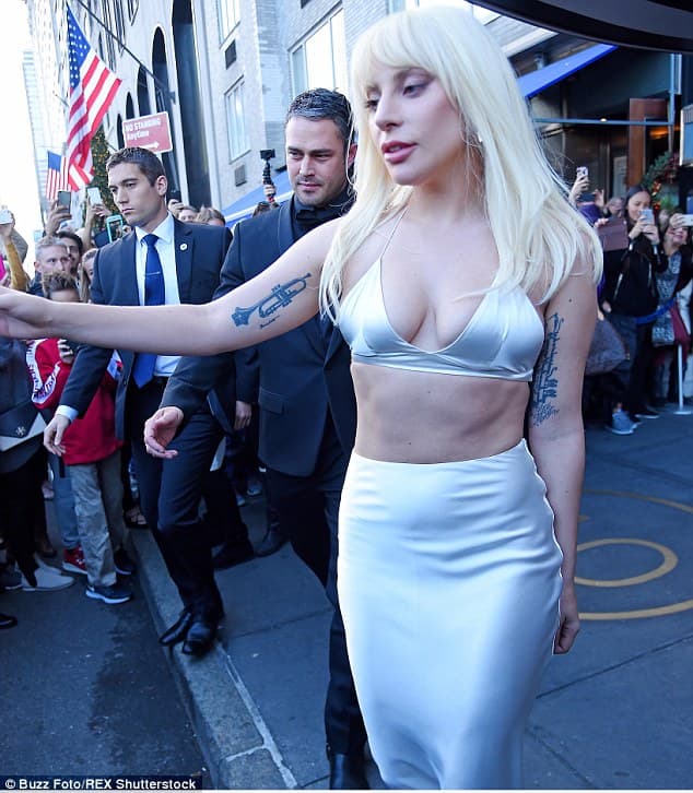 Lady Gaga wowed in all-white satin two-piece set, revealing her toned body while heading to Billboard 2015
